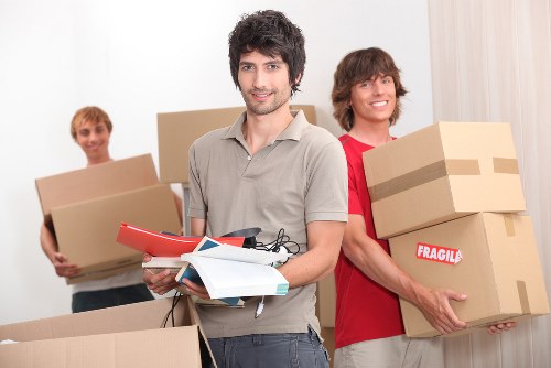 Man with van service loading household items into a moving van