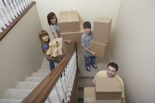 Moving team carrying items through a flat building in Brent